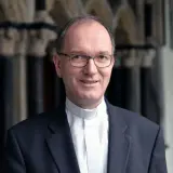 Porträt eines Mannes mit Brille und geistlichem Beffchen, der als Weihbischof in Aachen tätig ist.