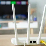 Router z antenkami, kluczowy element instalacji internetowej w domu. Zapewnia łączność dla telewizora i innych urządzeń.