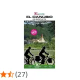 Ruta en bici por el Danubio, de Alemania a Austria. Paisaje fluvial con ciclistas y un pueblo con iglesia.