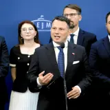 Konfederacja i europejscy eurosceptycy: prawdziwa historia współpracy. Politycy w garniturach na tle niebieskiej ściany.