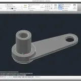 Model 3D elementu mechanicznego w formacie dwg. Widoczny jest cylinder połączony z płaskim ramieniem z otworem.