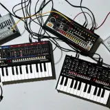 Ensemble de matériel pour composer musique électronique : synthétiseurs, boîtes à rythmes et câbles.