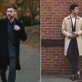 Deux hommes portant des manteaux, un noir et un beige, devant un mur de briques et dans un parc.