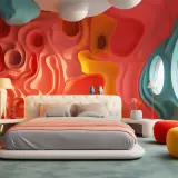 Dormitorio moderno con pared ondulada en tonos coral y amarillo. Cama blanca con ropa de cama gris y manta coral. Inspiración para modernos rayas en el pelo para niños.