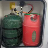 Deux bouteilles de gaz (verte et rouge) pour l'autonomie en camping-car. L'une est de 13 kg.