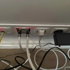 Gniazda ścienne z podłączonym kablem Ethernet, antenowym i zasilającym.