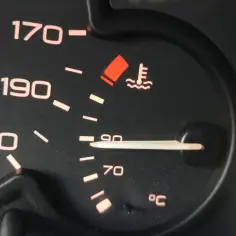Wskaźnik pokazuje, że temperatura oleju w silniku jest bliska 90°C. Czerwona kontrolka ostrzega przed przegrzaniem.
