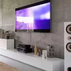 Nowoczesny salon z telewizorem, głośnikami i sprzętem RTV. Dowiedz się, jak podłączyć kino domowe do telewizora i dekodera, by cieszyć się kinowymi wrażeniami.