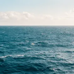 Bezmiar błękitnego oceanu, gdzie fale delikatnie falują. Czy jest większe morze czy ocean? To pytanie zadaje sobie każdy, kto patrzy na tę rozległą wodę.