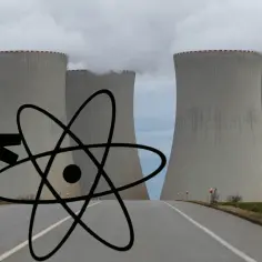 Człowiek pcha symbol atomu przed chłodniami elektrowni jądrowej.
