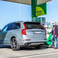 Mężczyzna tankuje szare Volvo XC60. Zastanawiasz się, ile spala Volvo XC60? Sprawdźmy!