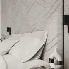 Nowoczesne kinkiety do sypialni nad łóżko tworzą przytulną atmosferę. Miękkie poduszki i teksturowana ściana dodają elegancji.