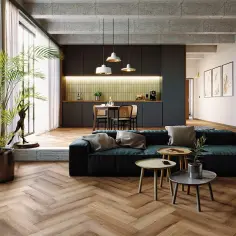 Nowoczesny salon z kuchnią. Drewniana podłoga w jodełkę dodaje elegancji. Sprawdź, jaka jest układanie paneli w jodełkę cena.