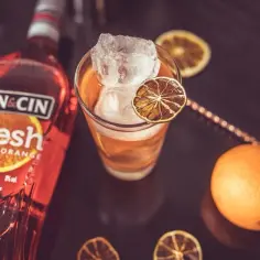 Orzeźwiający drink z Cin Cin Bianco Bitter Orange, lodem i suszoną pomarańczą. Idealny na lato!