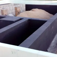 Fundament z bloczków betonowych, ciemna izolacja i piasek. Czekamy aż dysperbit wyschnie, by kontynuować budowę.