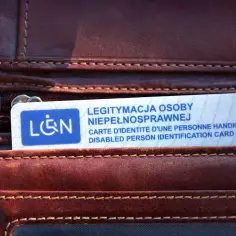 Legitymacja osoby niepełnosprawnej w portfelu. Posiadanie orzeczenia o niepełnosprawności w ciągu roku otwiera drogę do ulgi rehabilitacyjnej.