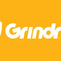 Logo Grindr na żółtym tle. Aplikacja randkowa dla gejów, podobna do Tindera.