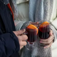 Para, trzymająca grzane wino z pomarańczą, zastanawia się, dlaczego po winie boli głowa: siarczyny a aminy biogenne.