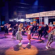 Aktorzy w teatrze Roma, jak kelnerzy, niosą tarty.