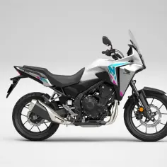 Biały motocykl Honda NX 500 z niebiesko-różowymi akcentami, gotowy na przygodę.