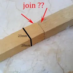Dwa drewniane kawałki połączone wzdłuż, z zaznaczonymi wymiarami 23mm i 20mm.