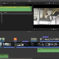 Edycja filmu w iMovie: oś czasu z klipami wideo, ścieżkami audio i podglądem sceny przemysłowej.