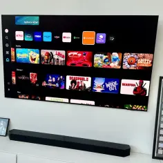 Telewizor z ekranem **amoled** wyświetla menu z aplikacjami streamingowymi: Netflix, Disney+, Max, Prime Video, YouTube, Spotify, Crunchyroll i Internet.