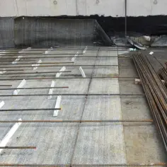 Zbrojenie na budowie, przygotowane do zalania betonem. Widać stalowe pręty i betonitowe podkładki dystansowe.
