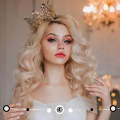 Blond panna w koronie, z makijażem i w sukni, symbolizuje pannę w ascendencie.