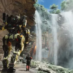 Potężny mech z gry Titanfall 3 stoi obok wodospadu, a pilot w czerwonym kombinezonie patrzy w jego stronę.