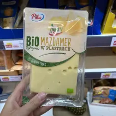 Opakowanie sera Mazdamer Bio w plastrach, promowane jako najzdrowszy ser żółty, z widocznym logo ekologicznym.