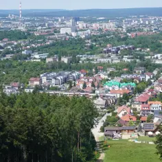 Widok na Kielce z góry, pokazujący zabudowania i zieleń. Wysokość nad poziomem morza jest tu wyraźnie odczuwalna.