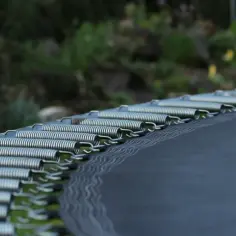 Sprężyny trampoliny gotowe do montażu. Dowiedz się, jak przymocować trampolinę do ziemi, by była bezpieczna.
