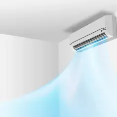 Klimatyzator ścienny emituje chłodne, niebieskie powietrze w pomieszczeniu.