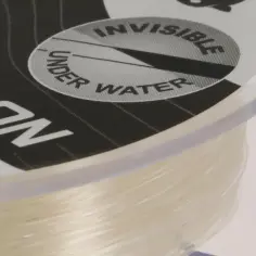 Nawinięta na szpulę żyłka wędkarska, z napisem "CARBON" i grafiką "INVISIBLE UNDER WATER".