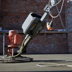 Robot do zacierania betonu pracuje na budowie, wygładzając świeżą posadzkę.