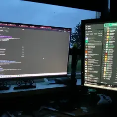 Dwa monitory pokazują, jak przerzucić grę na drugi monitor. Na lewym ekranie wyszukiwarka Google, na prawym Spotify.