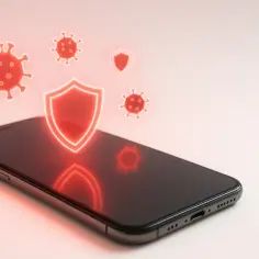 Czerwone ikony wirusów i tarczy ochronnej nad smartfonem iPhone.