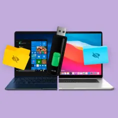Jak otworzyć pendrive na laptopie? Dwa laptopy, jeden z Windows, drugi z macOS, z pendrivem między nimi. Ikony folderów sugerują dostęp do danych.