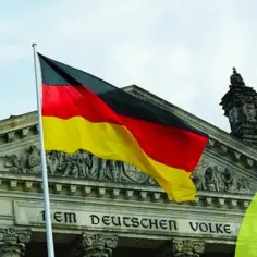 Flaga Niemiec przed Reichstagiem. Zastanawiasz się, ile zarabia monter rusztowań w Niemczech?