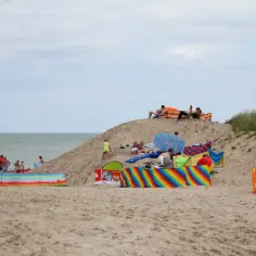 Ludzie odpoczywają na piaszczystej plaży nad morzem. Czy Gdańsk jest nad morzem? Tak, to widać!