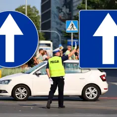 Policjant kieruje ruchem przy znakach droga jednokierunkowa. Biała strzałka na niebieskim tle informuje o nakazie jazdy prosto.