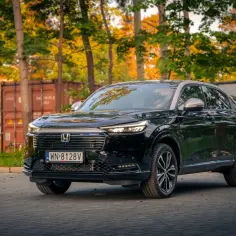 Czarny Honda HR-V na tle jesiennych drzew i kontenerów. Elegancki SUV gotowy na przygodę.
