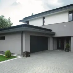 Nowoczesny dom z szarymi i białymi elewacjami, z ciemnym dachem i bramą garażową. Eleganckie kolory elewacji domów.