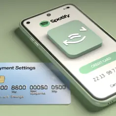 Telefon z aplikacją Spotify i karta płatnicza z napisem "Payment Settings".