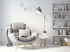 Un sillón cómodo junto a una estantería llena de libros, creando una acogedora biblioteca en casa.