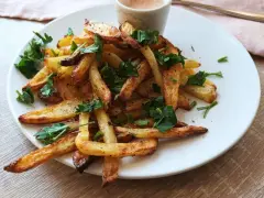 Chrupiące frytki z air fryera, posypane natką pietruszki. Idealne na szybki obiad, proste air fryer przepisy obiad.