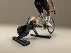 A cyclist rides indoors on a Wahoo Kickr Core 2 trainer, simulating an outdoor ride with realistic resistance.