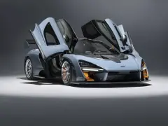 Niebieski McLaren Senna z otwartymi drzwiami, gotowy do startu.