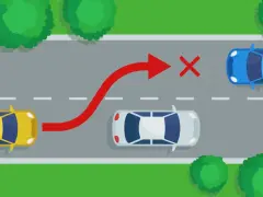 Żółty samochód próbuje niebezpiecznego **wymijania** niebieskiego auta, ignorując białe auto i czerwony znak zakazu.
